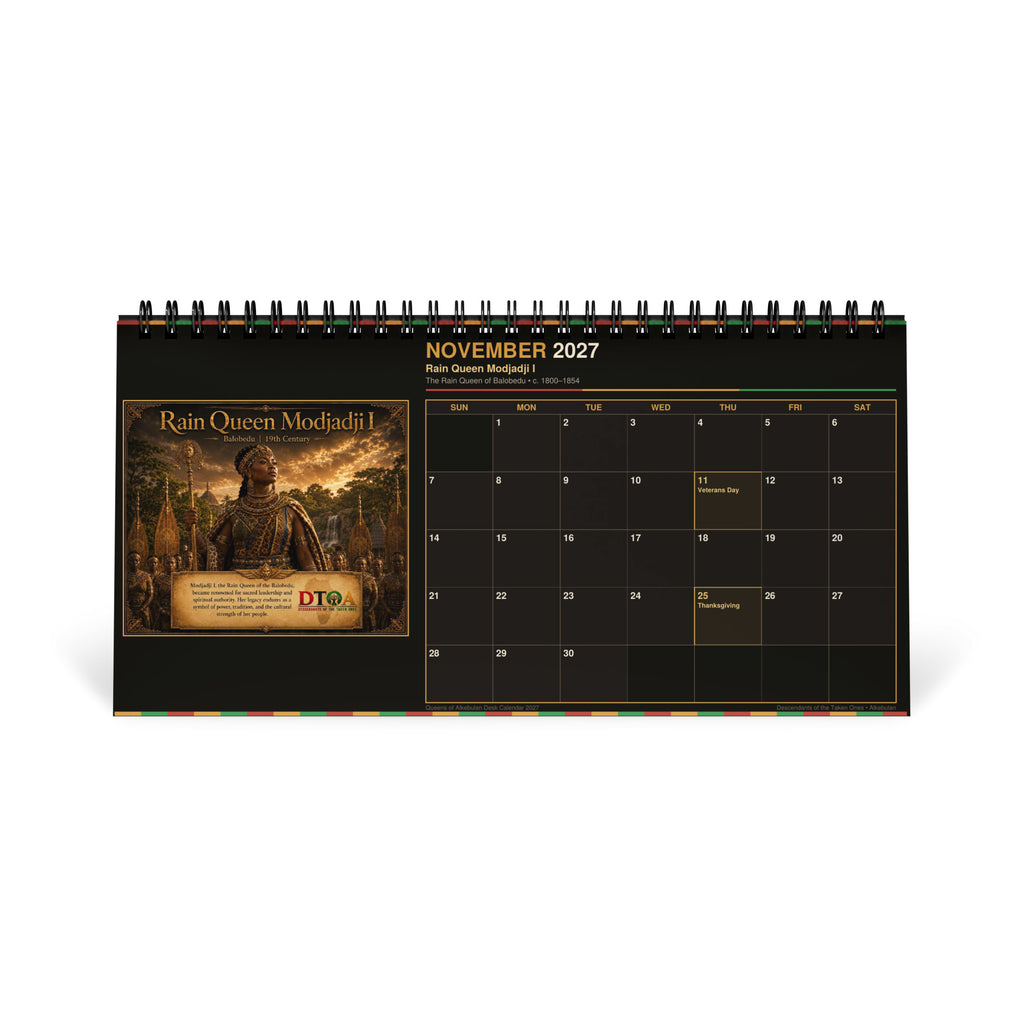 Queens of Alkebulan 2027 desktop calendar — product photo showing the standing desktop calendar and its DTOA artwork